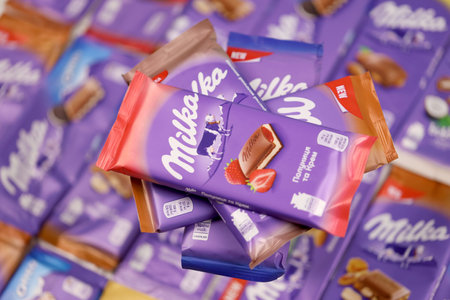 KHARKOV, UKRAINE - DECEMBER 8, 2020: Many wrappings of purple Milka chocolate. Milka is a Swiss...