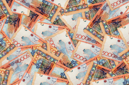 5000 Kazakhstani tenge bills lies in big pile. Rich life conceptual background. Big amount of money