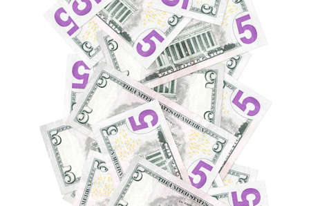 5 US dollars bills flying down isolated on white. Many banknotes falling with white copy space on...