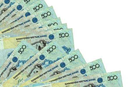 500 Kazakhstani tenge bills lies isolated on white background with copy space stacked in fan close...