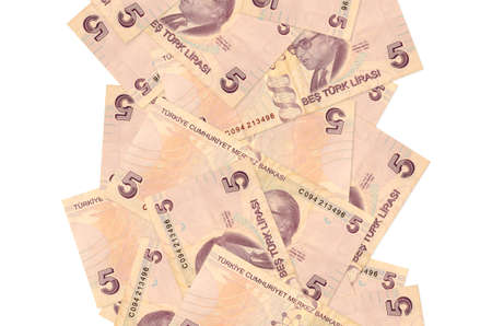 5 Turkish liras bills flying down isolated on white. Many banknotes falling with white copy space on...
