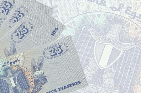 25 Egyptian piastres bills lies in stack on background of big semi-transparent banknote. Abstract...