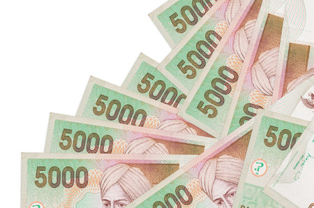 5000 Indonesian rupiah bills lies in different order isolated on white. Local banking or money making concept. Business background bannerの写真素材