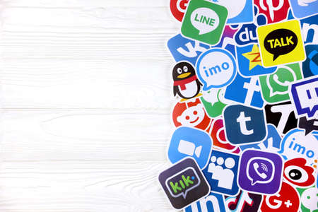 KHARKOV, UKRAINE - DECEMBER 26, 2020: Paper of most popular social networks and mobile messengers on wooden background. Facebook instagram youtube twitter tiktok twitch reddit and othersのeditorial素材