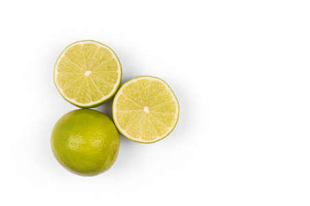 Halves or slices of green lime on light white background. Fresh fruits with copy space for textの写真素材