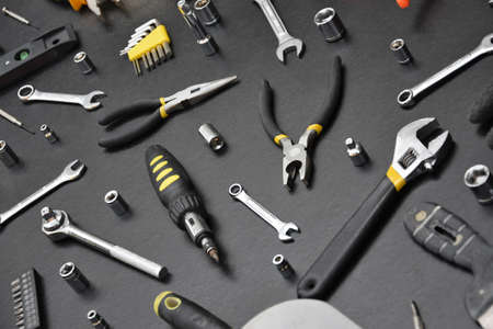 Handyman tool kit on black wooden table. Many wrenches and screwdrivers, pilers and other tools for any types of repair or construction works. Repairman tools setの写真素材