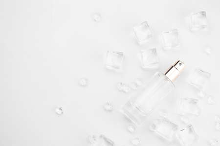 Female  bottle, objective photograph of  bottle in ice cubes and water. view from above. product photo, concept of freshness and aromaの写真素材