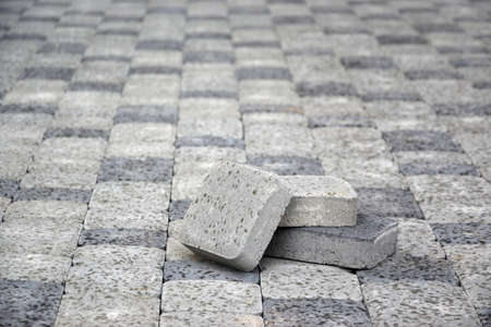 Small pile of gray walkway slabs lying in stack outdoors. Material for Paving Slabs by mosaic in...