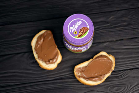 KHARKOV, UKRAINE - JULY 2, 2021: Can of Milka sweetened hazelnut cocoa spread with classical lilac...