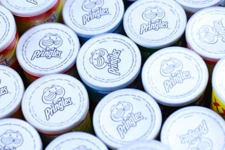 KHARKOV, UKRAINE - MARCH 30, 2021: Many Pringles cylinder chips boxes with varios colors and...