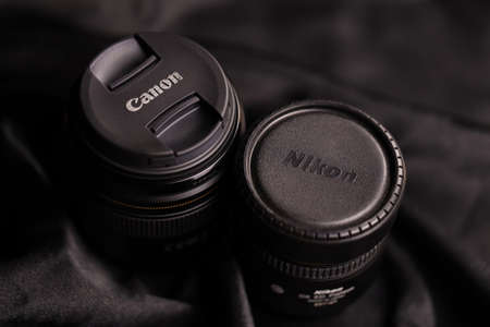 KHARKOV, UKRAINE - JANUARY 21, 2021: Canon EF 85mm 1.8 lens and Nikon 11.5mm 2.8 fisheye lens on...