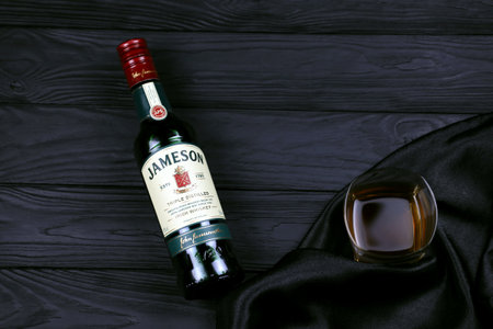 KHARKOV, UKRAINE - DECEMBER 3, 2020: Jameson triple distilled irish whiskey bottle on dark black background. Elite alcohol productionのeditorial素材