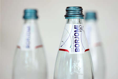 KHARKOV, UKRAINE - JULY 2, 2021: Glass of Borjomi brand of naturally carbonated mineral water from springs in the Borjomi Gorge of central Georgiaのeditorial素材