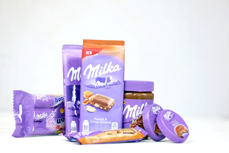 KHARKOV, UKRAINE - JULY 2, 2021: Milka chocolate products with classical lilac color wrapping design on white wooden tableのeditorial素材