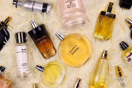 KHARKOV, UKRAINE - JANUARY 12, 2021: Many perfume bottles with famous brand names lies on fluffy beige plaid. luxury perfume setのeditorial素材