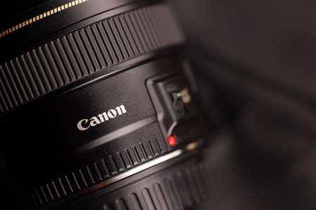 KHARKOV, UKRAINE - JANUARY 21, 2021: Canon EF 85mm 1.8 lens on black fabric background. Detailed photo of Canon brand productのeditorial素材