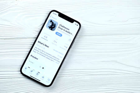 KHARKOV, UKRAINE - MARCH 5, 2021: Apple TV icon and application from App store on iPhone 12 pro display screen on white wooden tableのeditorial素材