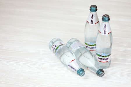 KHARKOV, UKRAINE - JULY 2, 2021: Glass of Borjomi brand of naturally carbonated mineral water from springs in the Borjomi Gorge of central Georgiaのeditorial素材