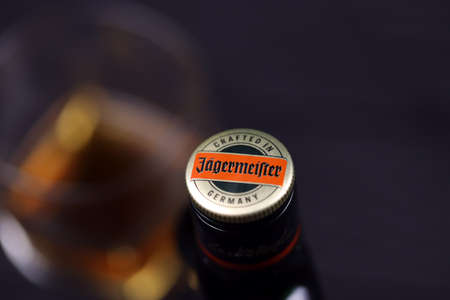 KHARKOV, UKRAINE - DECEMBER 3, 2020: Jagermeister cold macerated elixir bottle on dark black background. Elite alcohol productionのeditorial素材