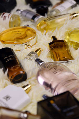 KHARKOV, UKRAINE - JANUARY 12, 2021: Many perfume bottles with famous brand names lies on fluffy beige plaid. luxury perfume setのeditorial素材