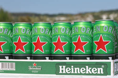 KHARKOV, UKRAINE - JULY 31, 2021: Green tin cans of Heineken pale lager beer produced by the Dutch brewing company Heineken NVのeditorial素材
