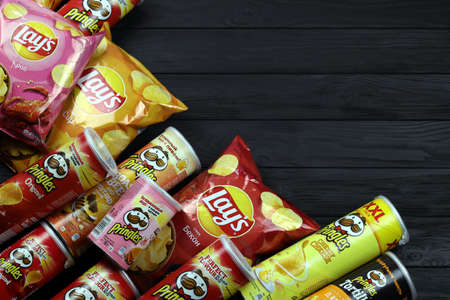 KHARKOV, UKRAINE - JANUARY 3, 2021: Various flavored of lay's and pringles potato chips in classic...