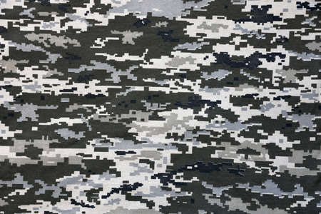 Fabric with texture of Ukrainian military pixeled camouflage. Cloth with camo pattern in grey, brown and green pixel shapes. Official uniform of Ukrainian soldiers close upの写真素材