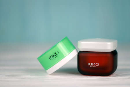 KHARKIV, UKRAINE - DECEMBER 16, 2021: Kiko Milano cream jars with company logo. Kiko Milano is a...