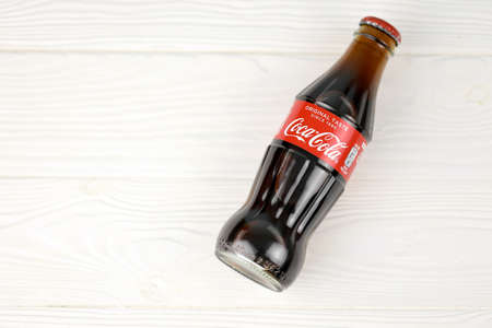 KHARKIV, UKRAINE - DECEMBER 16, 2021: Coca Cola production with classic company logo. Coca-Cola is a...