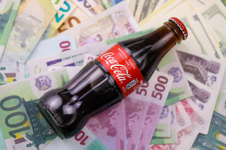 KHARKIV, UKRAINE - DECEMBER 16, 2021: Coca Cola production with classic company logo. Coca-Cola is a...