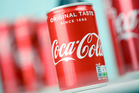 KHARKIV, UKRAINE - DECEMBER 16, 2021: Coca Cola production with classic company logo. Coca-Cola is a...
