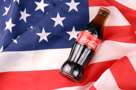 KHARKIV, UKRAINE - DECEMBER 16, 2021: Coca Cola production with classic company logo. Coca-Cola is a famous carbonated soft drink sold in stores, throughout the world.のeditorial素材