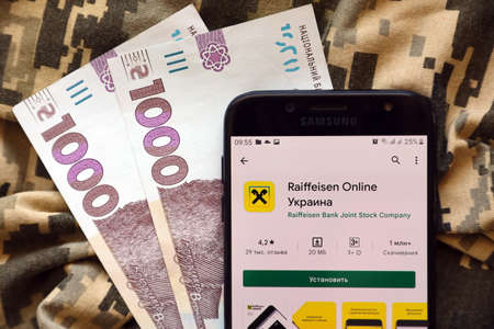 TERNOPIL, UKRAINE - APRIL 24, 2022: Raiffeisen banking application on smartphone screen. Raiffeisen is an important commercial bank in Ukraineのeditorial素材