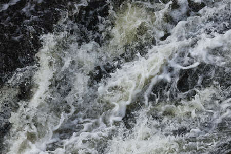 Waves of water of the river and the sea meet each other during high tide and low tide. Deep blue...