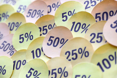 Large amount of yellow stickers with percentage values for black friday or cyber monday sale. Abstract image of discount prices for any goodsの写真素材
