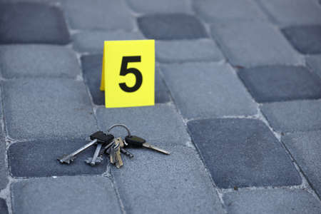 Evidence with yellow CSI marker for evidence numbering on the residental backyard in the evening....