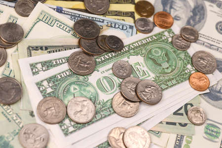 US money bills and coins close up. Big amount of american dollars on table. business and budget...