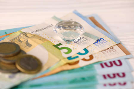 Euro money bills and coins with large diamond close up. Big amount of euro money and huge...