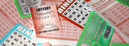 Many used lottery tickets, bills with numbers and bingo playing boards in big pile. Gambling and lottery paper stuff close upの写真素材
