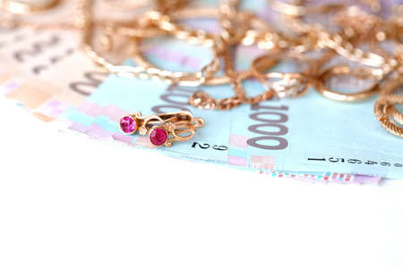 Many expensive golden jewerly rings, earrings and necklaces with big amount of Ukrainian money...