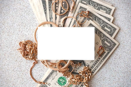 Many expensive golden jewerly rings, earrings and necklaces with big amount of US dollar bills with...