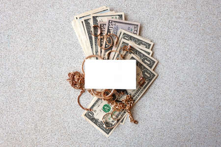 Many expensive golden jewerly rings, earrings and necklaces with big amount of US dollar bills with...