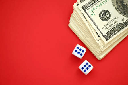 Money, finance and gambling concept. Close up on an American hundred US dollar banknotes and two...