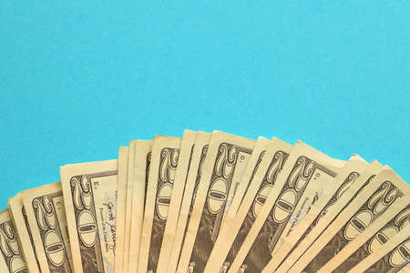 Big amount of old twenty dollar bills on blue background. Money earnings, payday or tax paying period conceptの写真素材