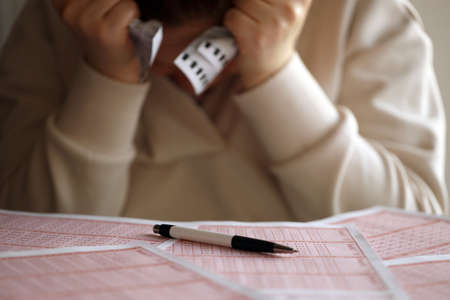 A sad young girl suffers from a loss after looking the unlucky result of the lottery gambling. The...