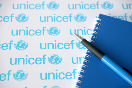 TERNOPIL, UKRAINE - MAY 2, 2022: Blue notepad and pen from UNICEF - United Nations programm that provides humanitarian and developmental assistance to children in developing countriesのeditorial素材