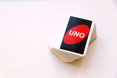 TERNOPIL, UKRAINE - MAY 15, 2022: Many colorful UNO game cards on white background close up. UNO is an American shedding-type card game that is played with a specially printed deckのeditorial素材