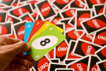 TERNOPIL, UKRAINE - MAY 15, 2022: Many colorful UNO game cards. UNO is an American shedding-type card game that is played with a specially printed deck. UNO has been a Mattel brand since 1992のeditorial素材