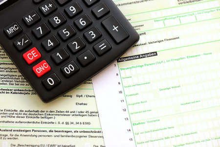 German annual income tax return declaration and calculator lies on accountant table close up. The...