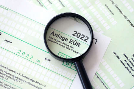 Anlage EUR - German 2022 Profit and Loss Statement and magnifying glass close up. The concept of...